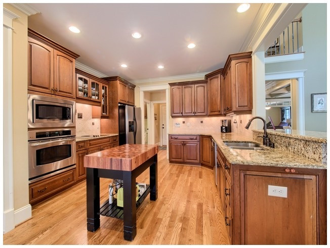 The open, gracious kitchen is a chef's delight with S/S appliances, granite countertops, u/m sink and faucet with pull out sprayer and loads of storage! Kitchen
