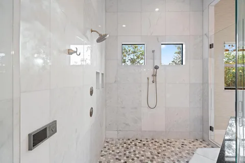 a bathroom with a granite countertop sink a toilet and shower