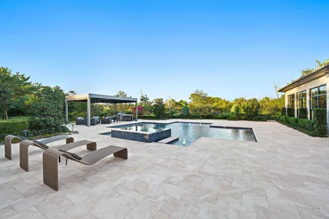 a view of a house with a yard and mountain view in back