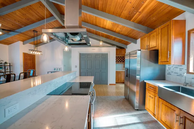 a kitchen with stainless steel appliances wooden cabinets a sink and a stove