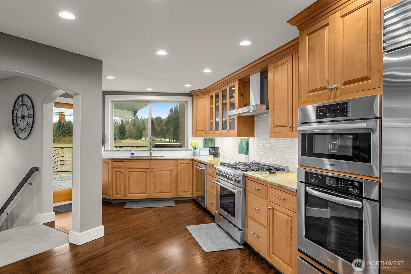 7909 Fern Glen Road Lake Stevens, WA 98258 - Photo 13 of 40 a kitchen with stainless steel appliances granite countertop a stove a sink and a refrigerator