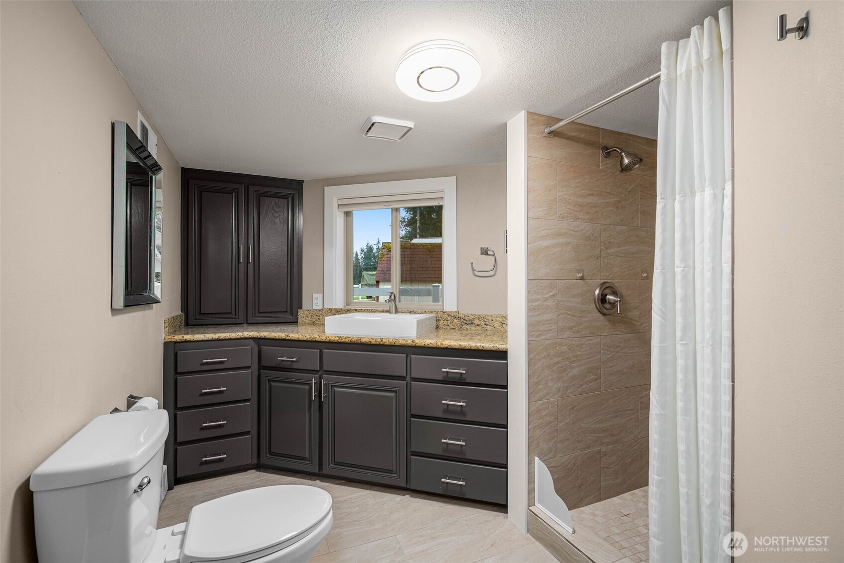 7909 Fern Glen Road Lake Stevens, WA 98258 - Photo 30 of 40 a bathroom with a toilet a sink and mirror