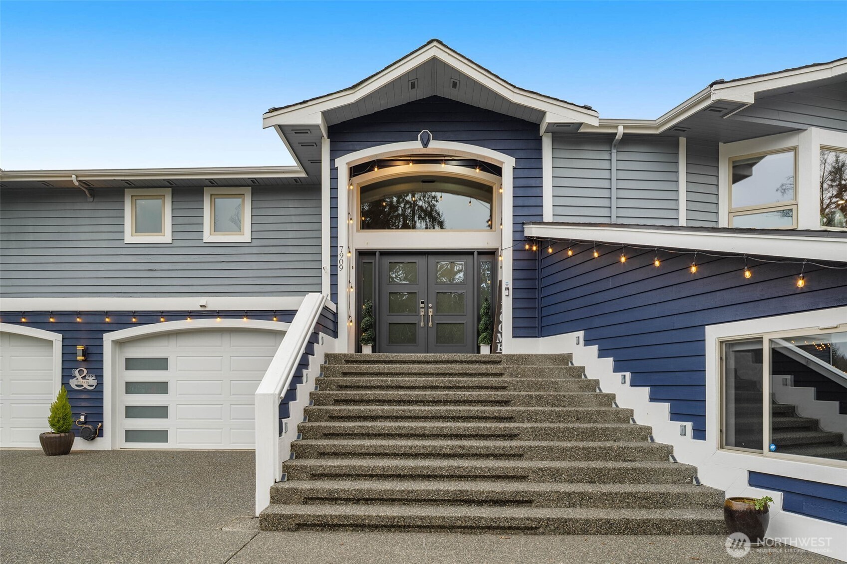 7909 Fern Glen Road Lake Stevens, WA 98258 - Photo 4 of 40 a front view of a house with stairs and a white door