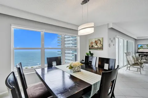 a kitchen with white cabinets and appliances