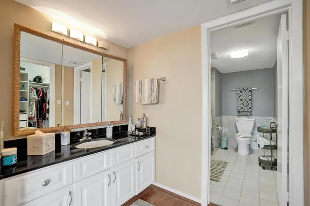 a white toilet sitting next to a bathroom sink