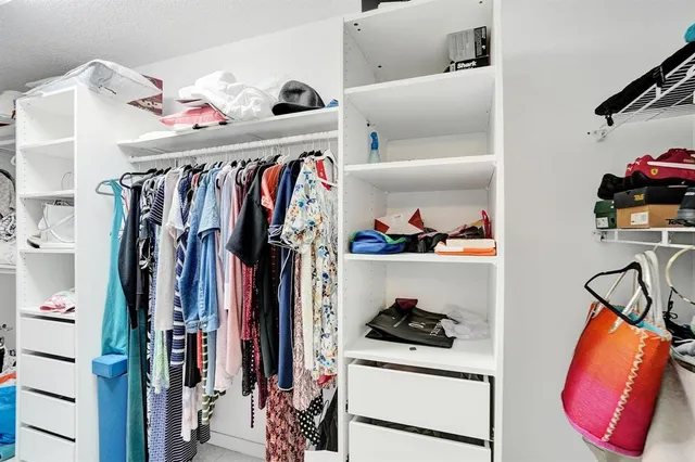 a bedroom with a bed and a lamp