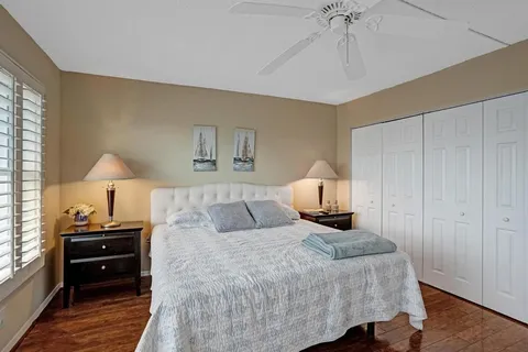 a bedroom with a bed next to a window