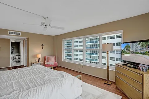 a bedroom with a large bed and a large window