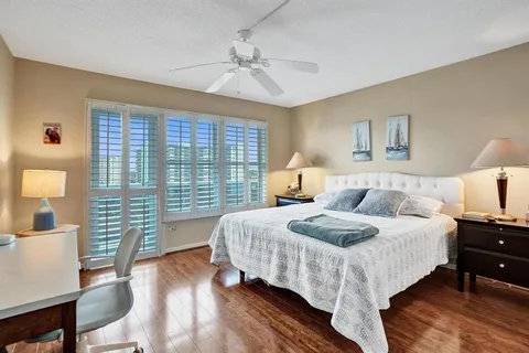 a bedroom with a bed a mirror and a window