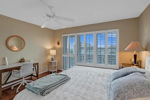 a bathroom with a granite countertop sink a toilet a mirror and vanity