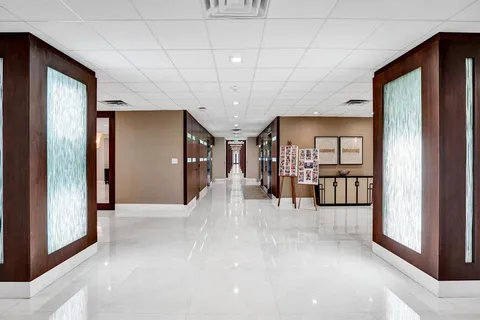 a living room with furniture and a potted plant