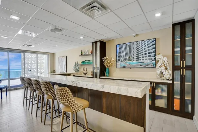 a living room with furniture and a book shelf