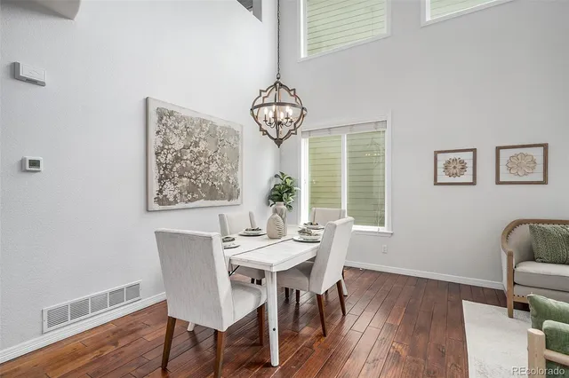 a view of a livingroom with wooden floor and furniture