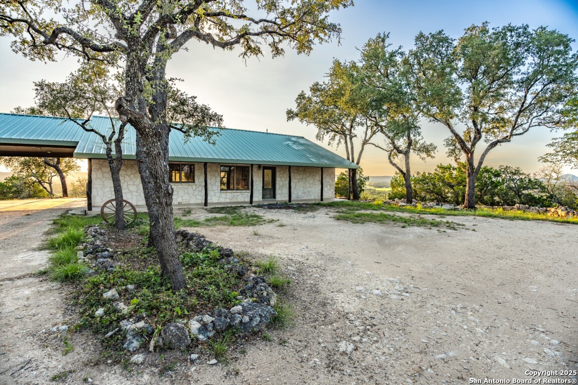 599 Mountain View Road Utopia, TX 78884 - Photo 27 of 38 a front view of a house with a garden