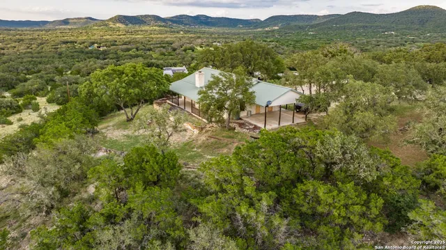 a view of a field with mountains in the background