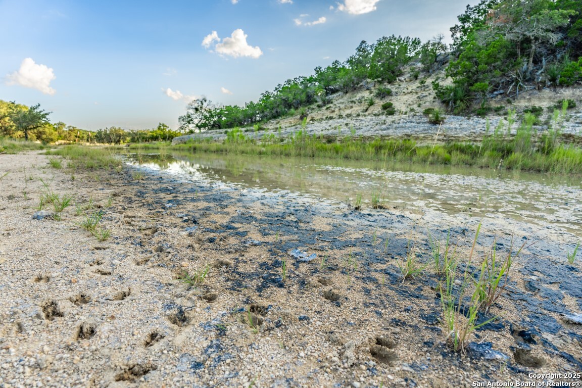 599 Mountain View Road Utopia, TX 78884 - Photo 32 of 38 a view of a lake with a big yard