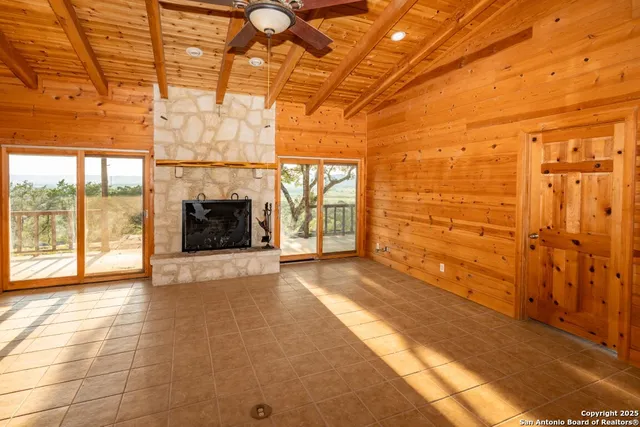 a view of an empty room with a fireplace