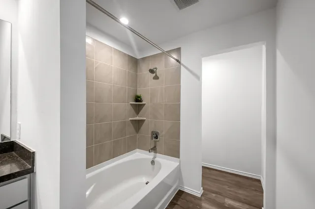 a bathroom with a bathtub and a shower