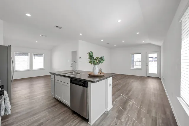 a kitchen with stainless steel appliances granite countertop a sink and stove top oven