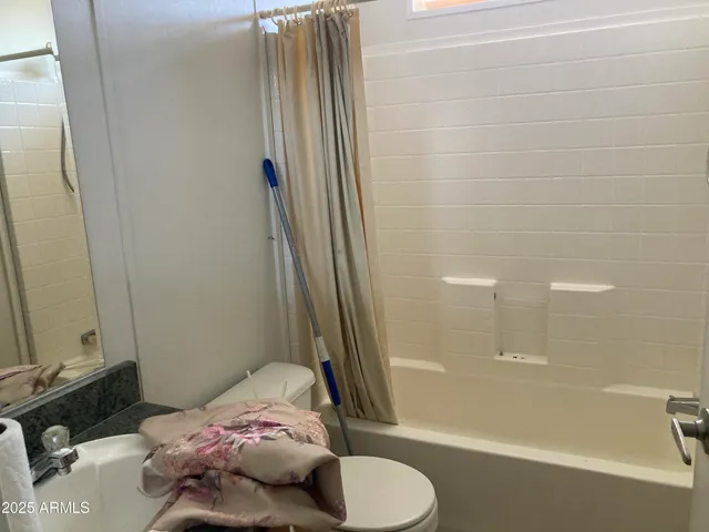 a bathroom with a bathtub and shower