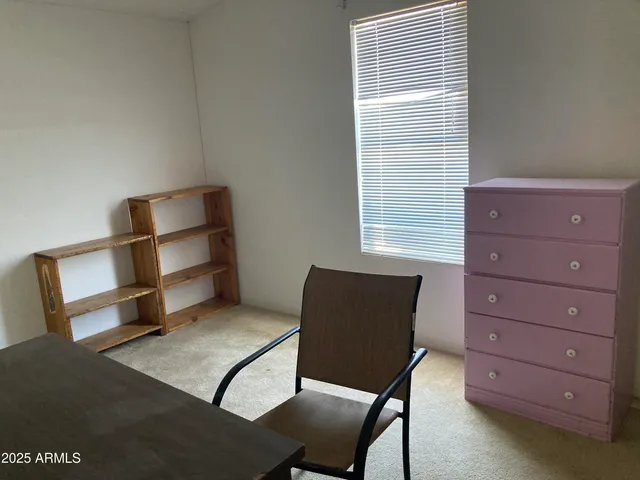 a room with a chair and a dresser