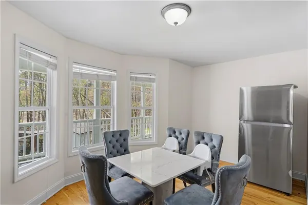 a view of a dining room with furniture window and wooden floor