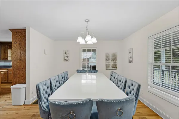 a dining room with furniture a rug and wooden floor
