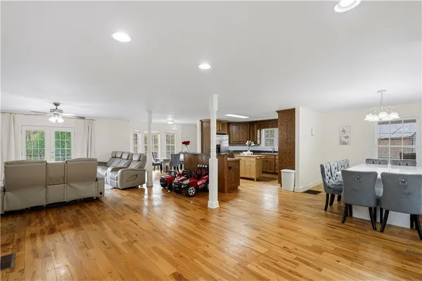 a living room with furniture and kitchen view