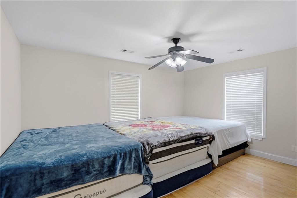 262 Iron Hill Road Taylorsville, GA 30178 - Photo 17 of 38 a bedroom with a bed and a chandelier