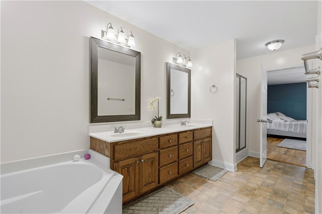 262 Iron Hill Road Taylorsville, GA 30178 - Photo 24 of 38 a bathroom with a tub sink and mirror