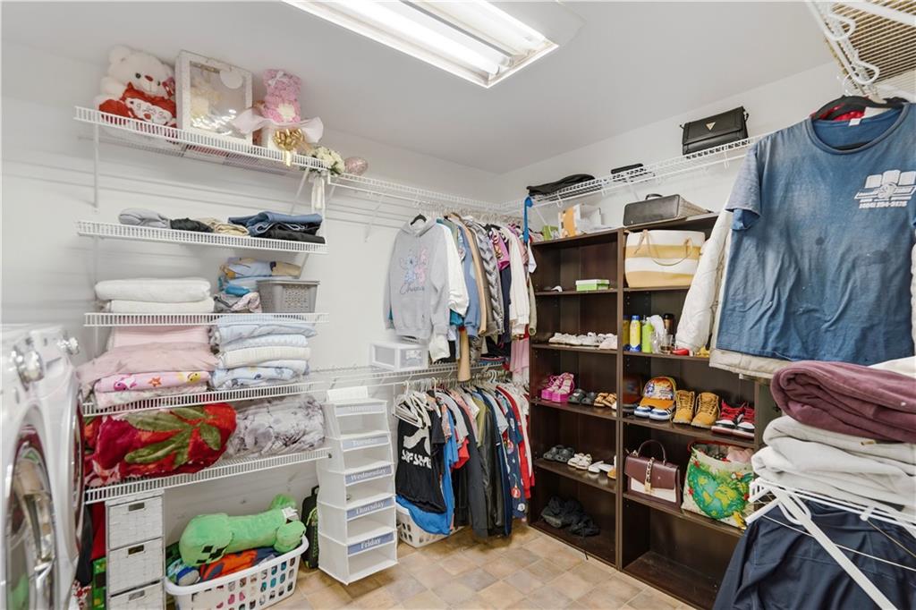 262 Iron Hill Road Taylorsville, GA 30178 - Photo 25 of 38 a view of walk in closet with clothes and shoes