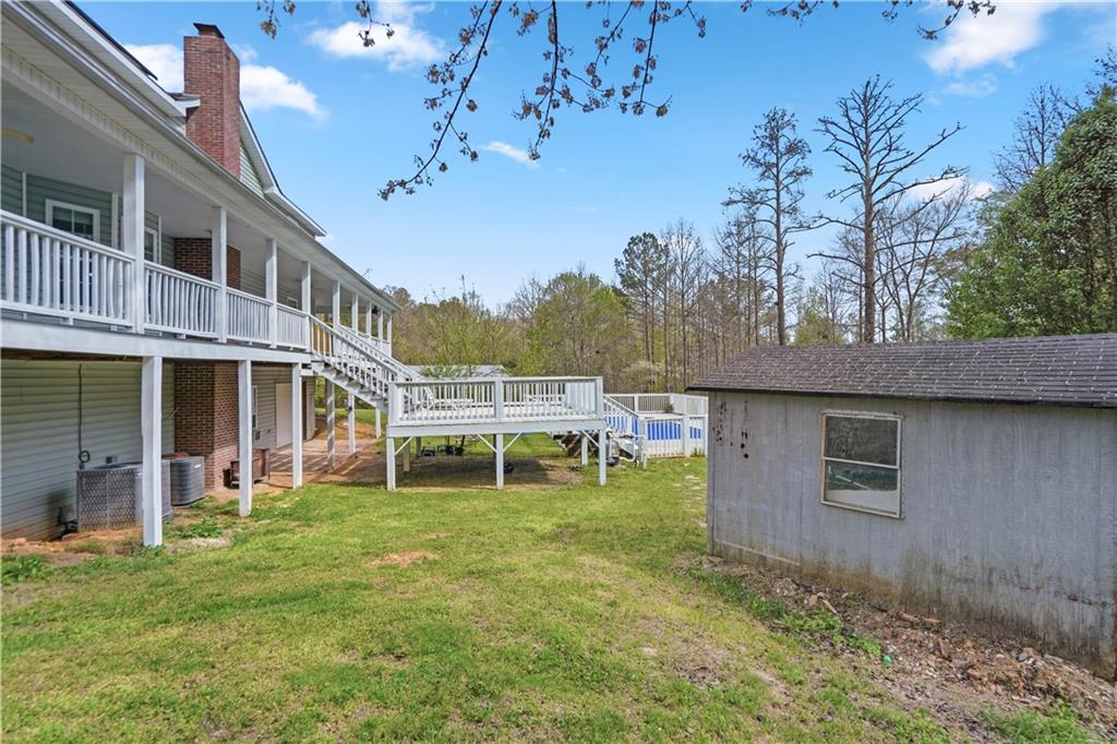 262 Iron Hill Road Taylorsville, GA 30178 - Photo 32 of 38 a backyard of a house with table and chairs