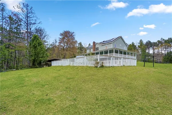 a view of a house with a backyard and a garden