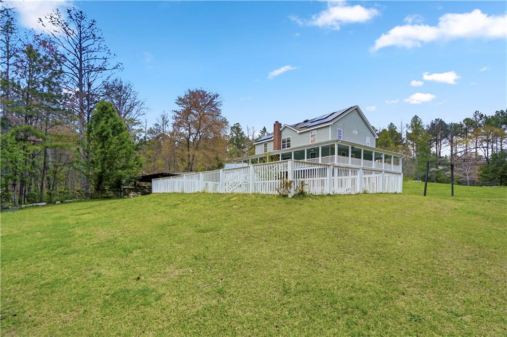 262 Iron Hill Road Taylorsville, GA 30178 - Photo 36 of 38 a view of a house with a backyard and a garden