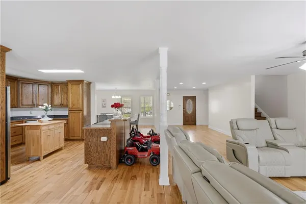 a very nice looking room with a large window wooden floor and stainless steel appliances