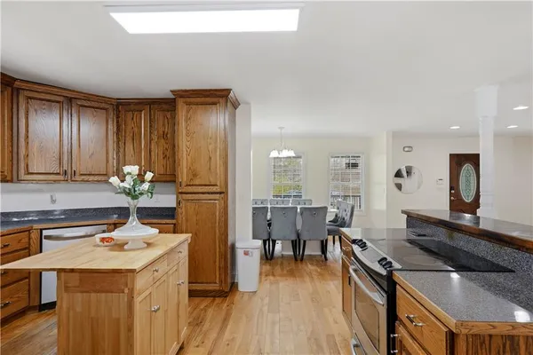a kitchen with stainless steel appliances granite countertop a stove refrigerator and cabinets