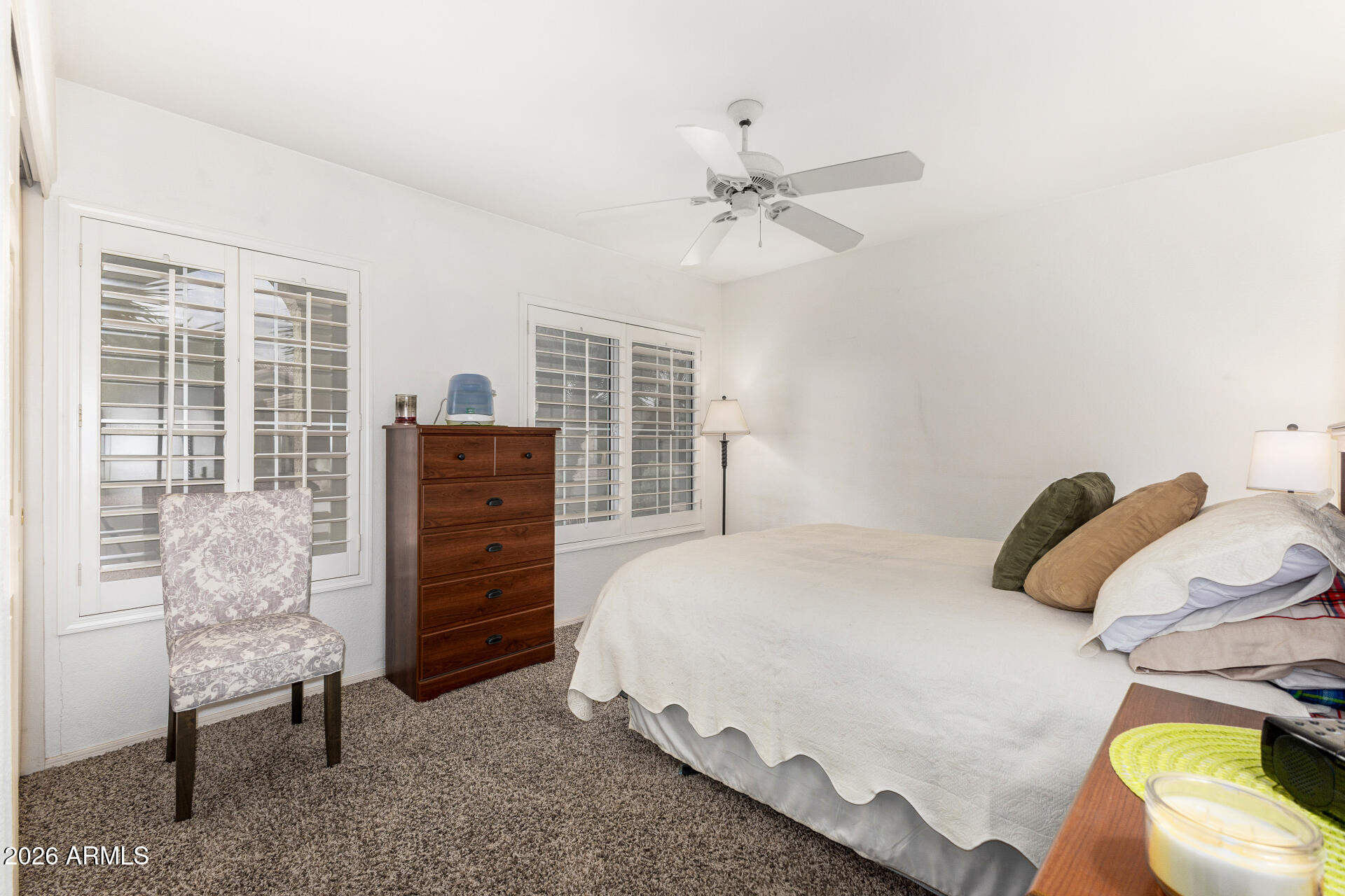 15764 Piccadilly Road Goodyear, AZ 85395 - Photo 21 of 31 a bedroom with a bed and dresser