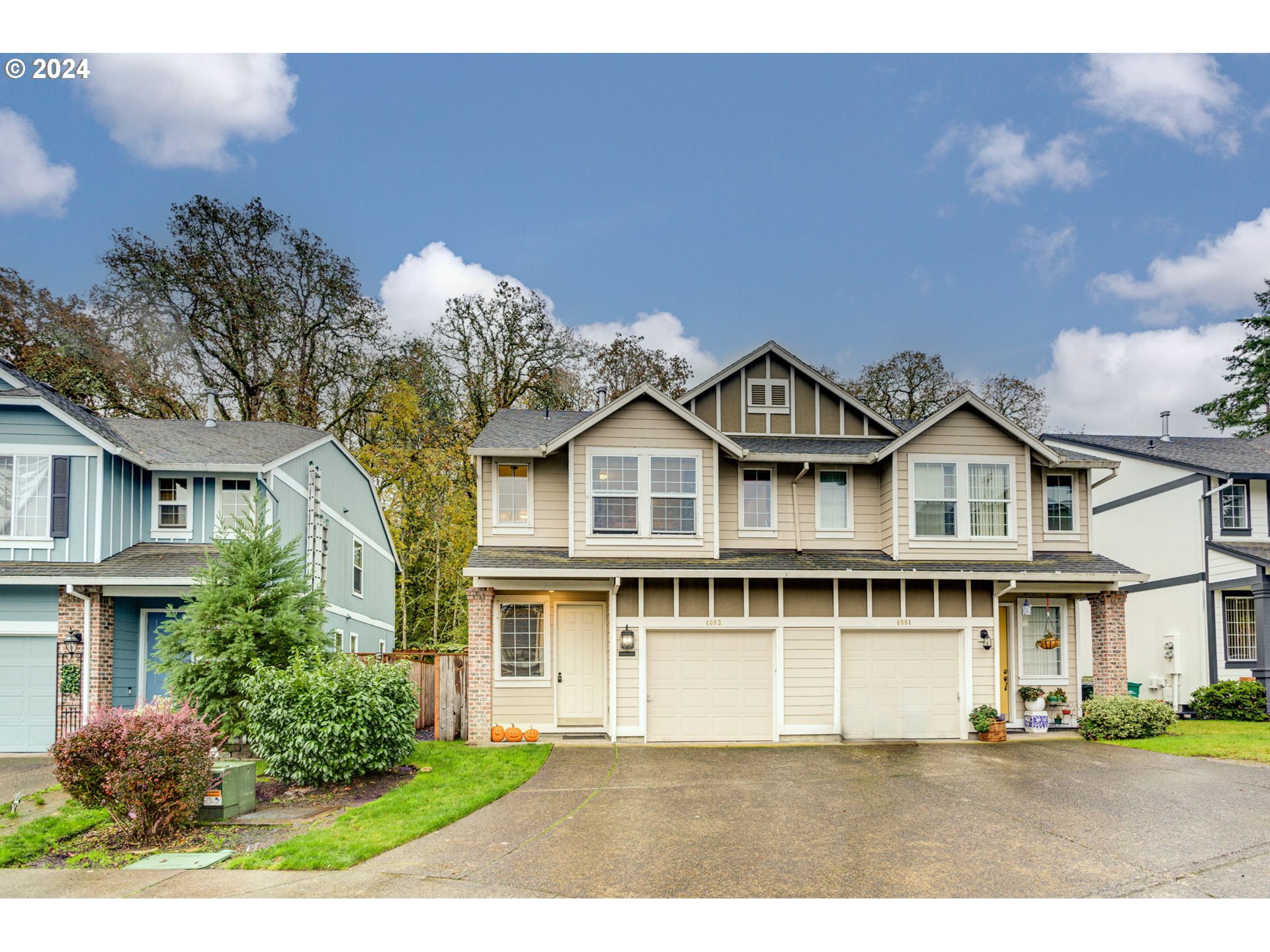 a front view of a house with a garden and a yard