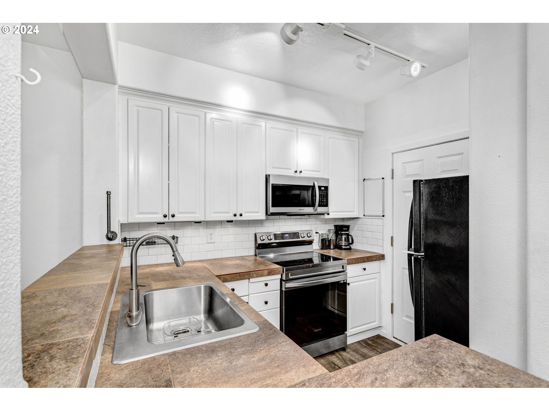4083 Southwest 182nd Place Beaverton, OR 97078 - Photo 14 of 33 a kitchen with stainless steel appliances granite countertop a stove a sink and a refrigerator