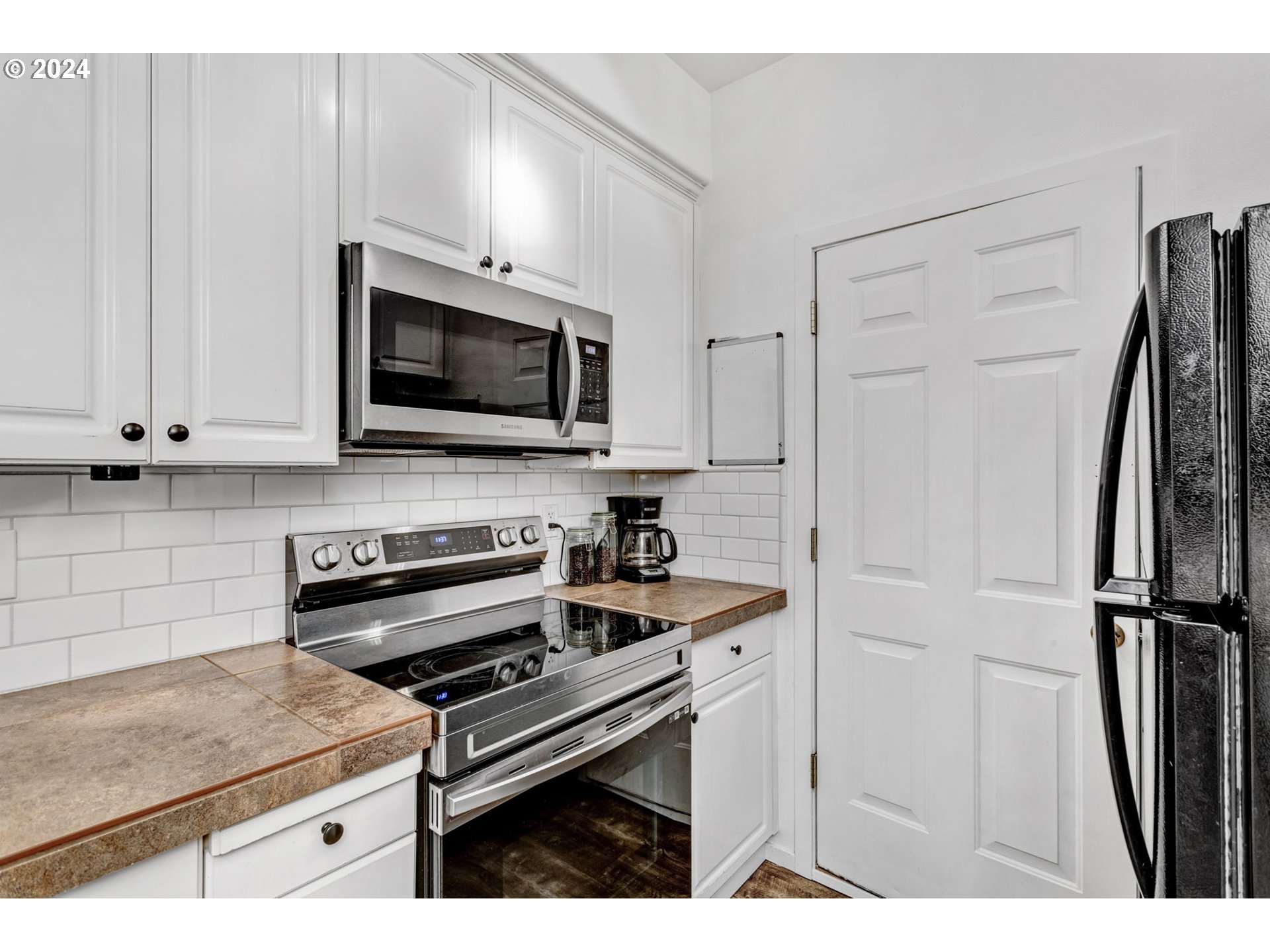 4083 Southwest 182nd Place Beaverton, OR 97078 - Photo 17 of 33 a kitchen with stainless steel appliances a stove a microwave and a refrigerator
