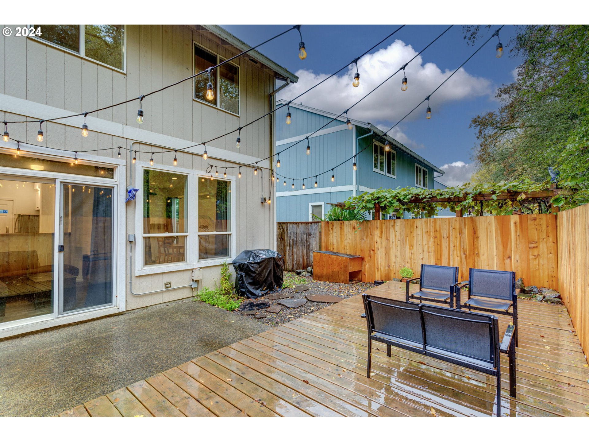 4083 Southwest 182nd Place Beaverton, OR 97078 - Photo 28 of 33 a backyard of a house with a swing table and chairs