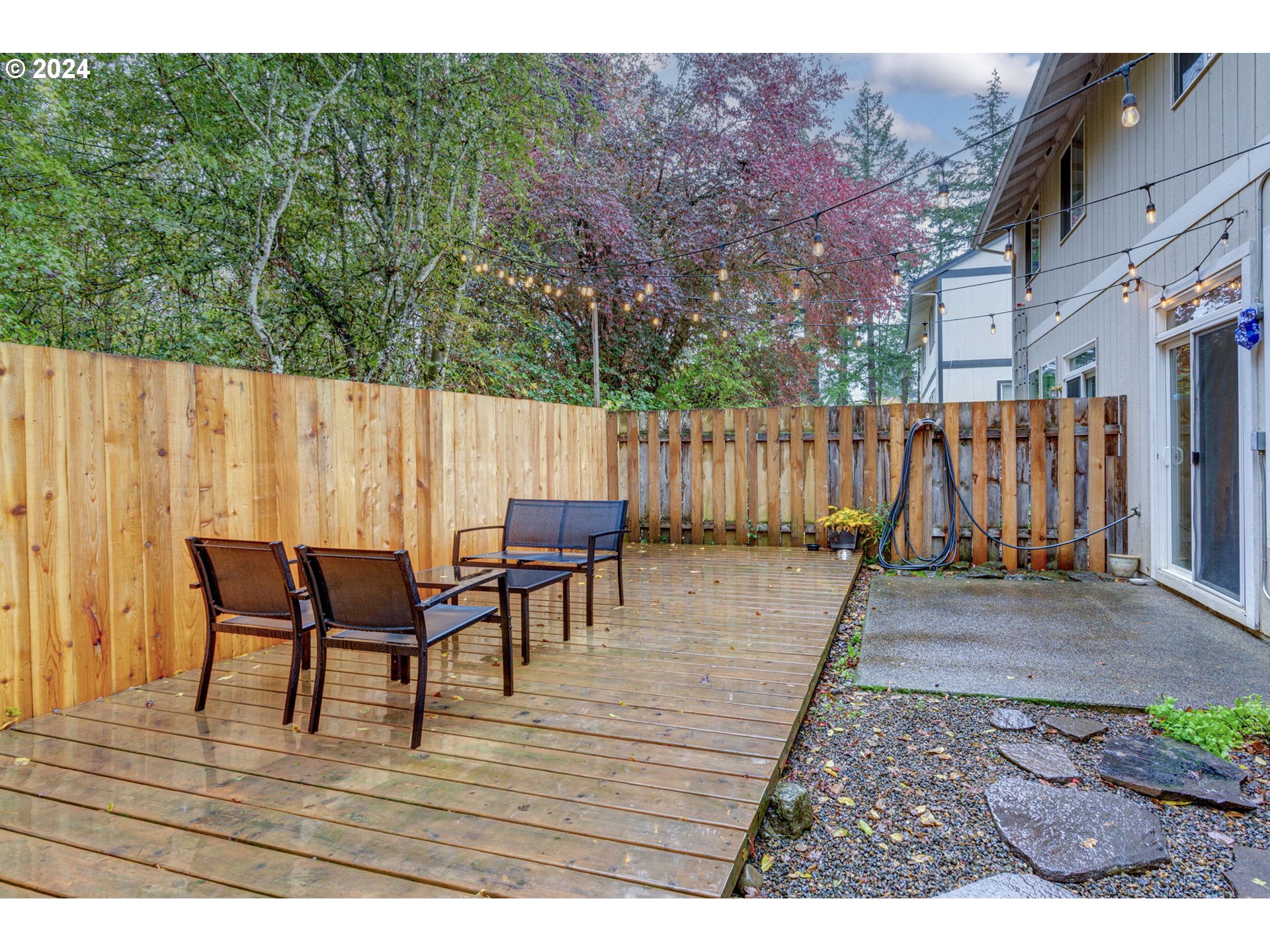 4083 Southwest 182nd Place Beaverton, OR 97078 - Photo 29 of 33 a view of a patio with table and chairs with wooden floor and fence