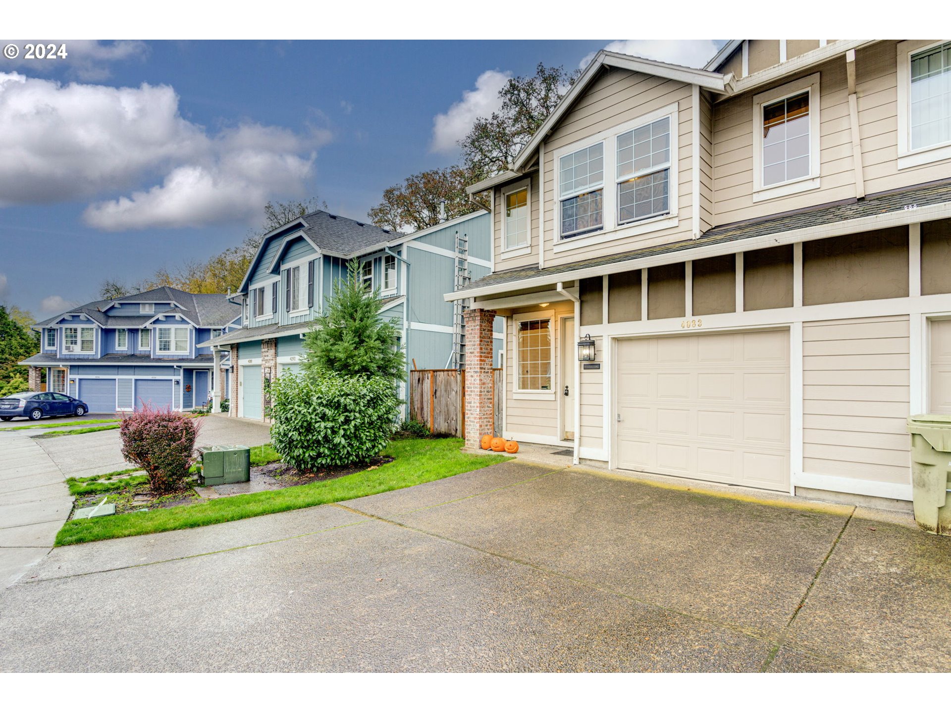 4083 Southwest 182nd Place Beaverton, OR 97078 - Photo 3 of 33 a front view of a house with a garden and garage