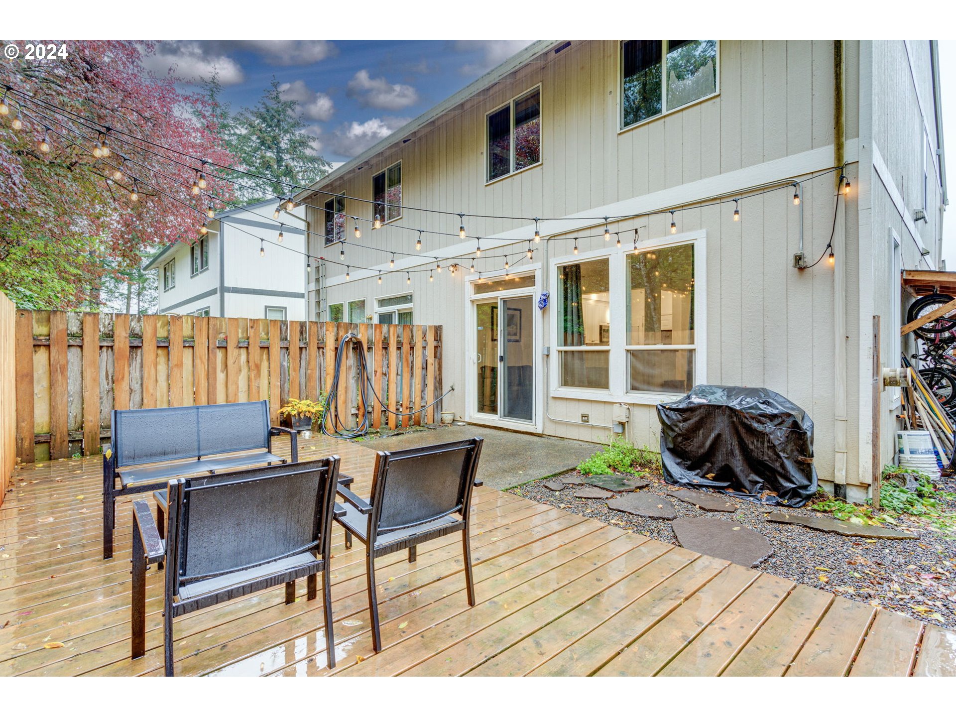 4083 Southwest 182nd Place Beaverton, OR 97078 - Photo 31 of 33 a backyard of a house with a fountain swing table and chairs