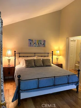 a bedroom with a bed and a night stand