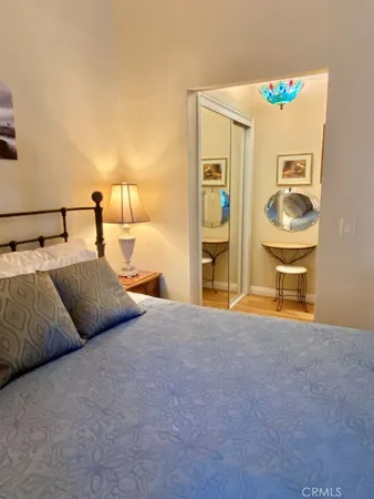 a bedroom with a bed and painting on the wall