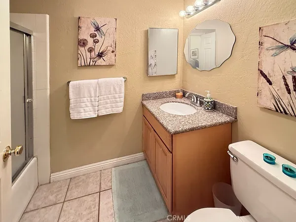 a bathroom with a toilet a sink and a mirror