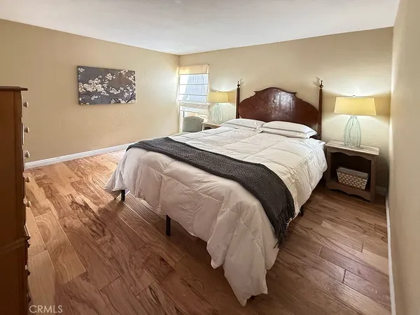 a bedroom with a bed and a night stand