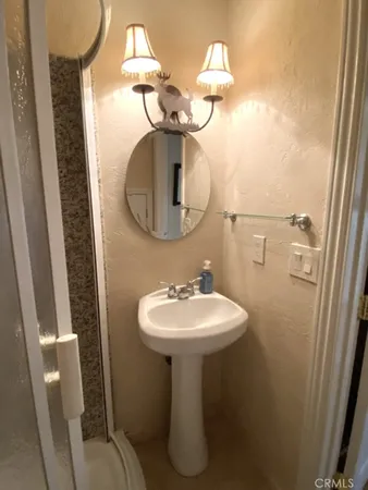 a bathroom with a sink toilet and mirror