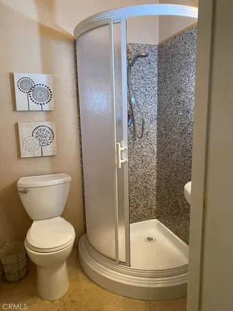 a bathroom with a toilet and a shower